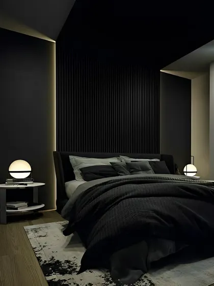A bold, all-black bedroom design for a sophisticated and modern look. The vertical fluted paneling behind the bed adds texture, while soft, warm lighting creates an intimate and cozy ambiance.