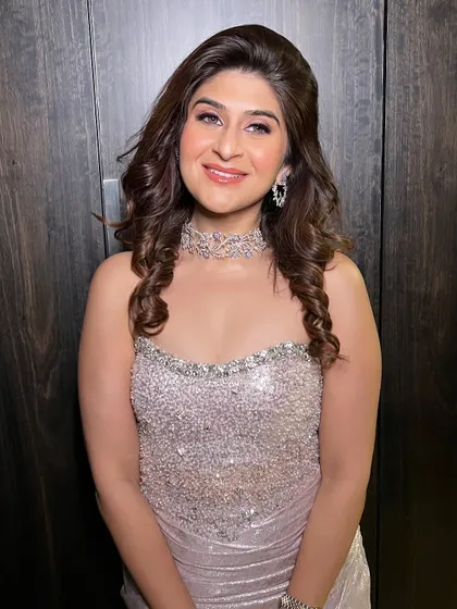 All set for a Diwali party, shining bright in a silver sequined dress. The makeup features a soft pink smokey eye and glowing skin for a festive and glamorous look.