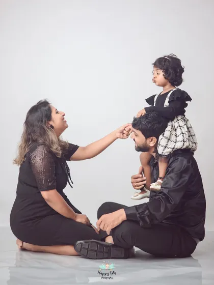 A sweet, interactive family pose on the studio floor. Getting down on the kids' level helps create a comfortable and intimate setting for photos.