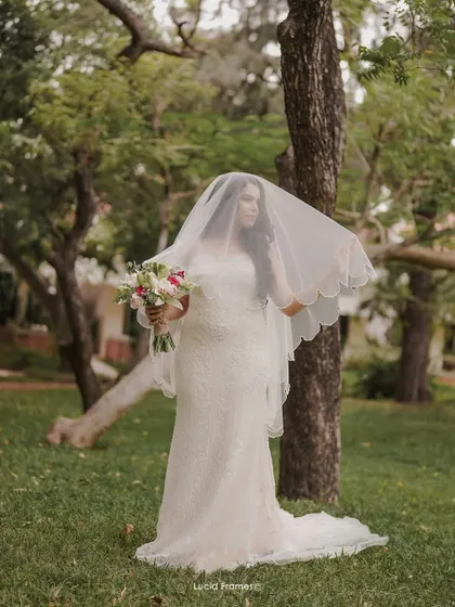 An ethereal portrait of the bride under her veil, creating a soft and mysterious look.