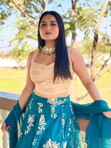 A portrait shot showcasing the details of my blue embroidered lehenga and statement jewelry. I love creating a complete look that complements the event's decor and theme.