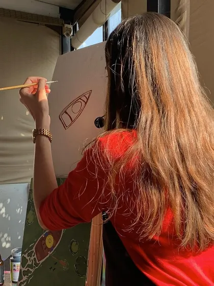 A guest lost in the creative process at our studio. With the beautiful view and relaxed atmosphere, it's the perfect place to unwind and let your imagination take over.