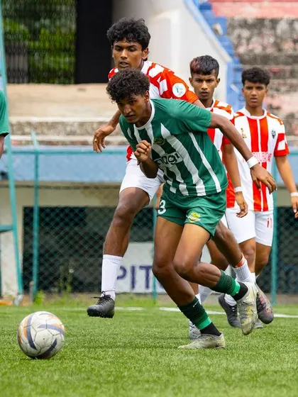 A player accelerates with the ball, leading a counter-attack with teammates in support against a retreating defense.