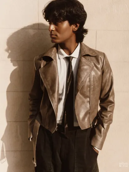 A clean, masculine grooming look for a men's fashion shoot. The focus is on natural-looking skin and styled, but not overdone, hair.