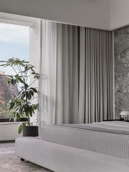 The daughter's bedroom offers a lighter mood, with a predominantly white shell and a headboard wall clad in rugged finished granite.