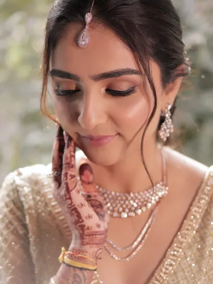 A close-up of the bride's soft and minimal makeup, paired with a gentle updo. This look is perfect for the bride who wants to feel like herself, only elevated.