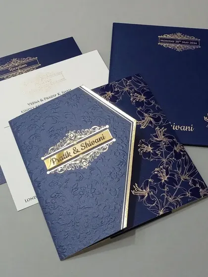 A sophisticated navy blue invitation set with gold foil accents. The textured paper and classic design exude elegance.