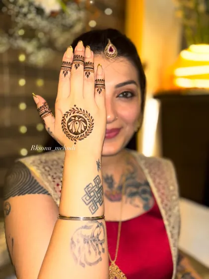 A chic and artistic choice for a modern bride. This design features a simple lotus mandala on the back of the hand and a graceful peacock on the palm, leaving plenty of open space.