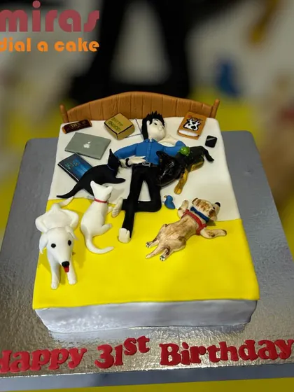 A cake for the ultimate pet lover. This design shows a person happily surrounded in bed by their beloved dogs and cats, along with a laptop and books. It's a perfect snapshot of a cozy life.