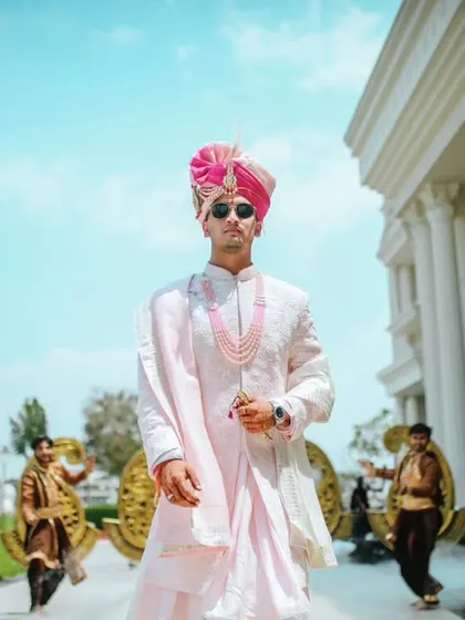 The groom's stylish entry, flanked by performers, setting a grand and festive tone for the wedding.