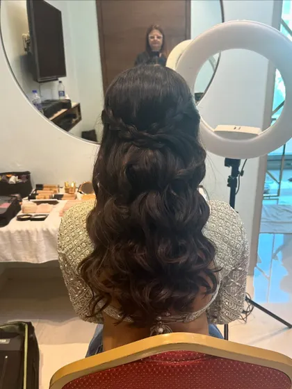 A behind-the-scenes look at this hairstyle. The soft waves are created first, then gathered into a simple, elegant half-up twist.