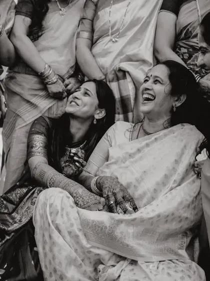 A candid shot of a bride sharing a laugh with her mother during the festivities. The joy in their faces is just beautiful.