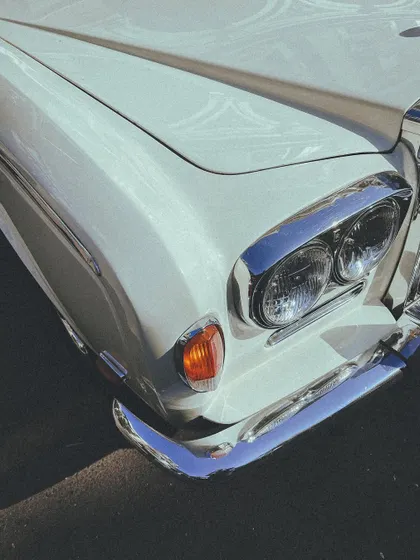 The elegant lines and chrome details of a classic Rolls-Royce, a symbol of timeless design.