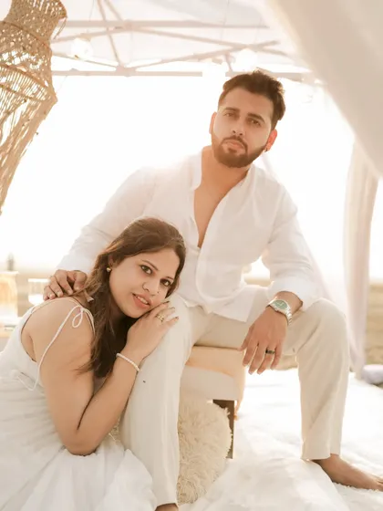 A stylish and relaxed portrait from a beach pre-wedding session, capturing the couple's cool confidence.