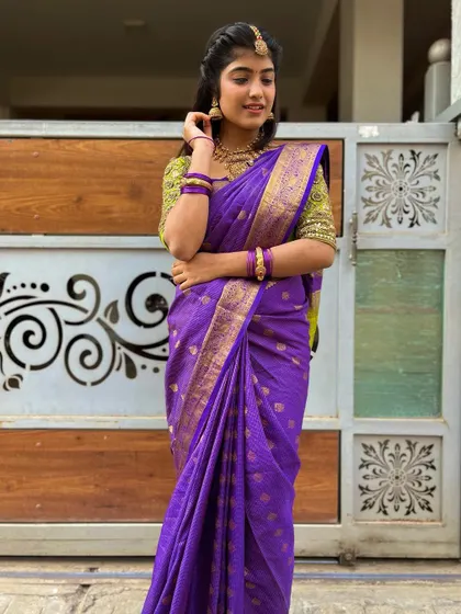 The beautiful drape of the purple silk saree, available for rent.