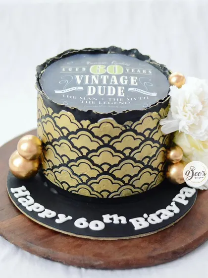 Celebrating a 60th birthday in style with this "Vintage Dude" cake. The black and gold design features a cool retro print and intricate stencil work.