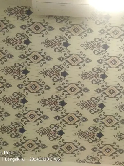 An ikat-patterned wallpaper installed on a wall.