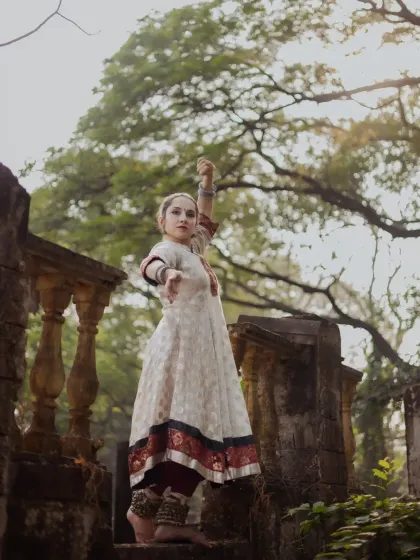 A dramatic pose set against old stone ruins. The dancer's upward reach and the historic setting create a timeless portrait that blends art, history, and nature.