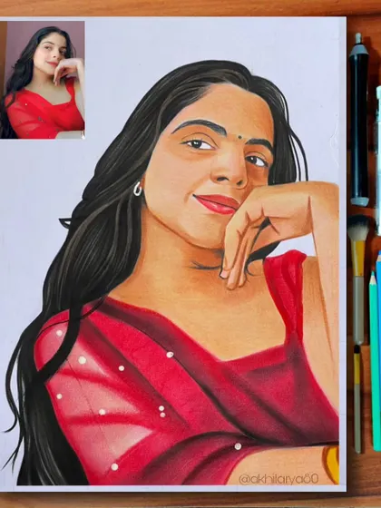 A vibrant portrait of a woman in a red saree, drawn on A4 paper. The rich red color was built up in layers using colored pencils to achieve this deep, eye-catching shade.