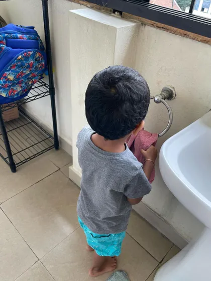 Taking care of our environment extends to every corner of the school. Here, a child practices a cleaning exercise, developing motor skills and a sense of pride in maintaining a beautiful space.