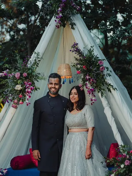 For intimate celebrations, we focus on creating cozy and stylish spaces. This elegant teepee, adorned with delicate florals, served as a perfect, personal backdrop for the couple's portraits.