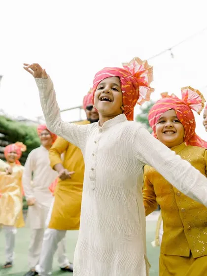 Even the youngest guests get in on the fun! We love capturing the energy of all family members, including these children dancing at a Haldi ceremony.