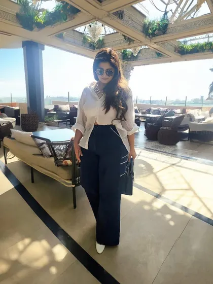 A shot capturing the flow and movement of the wide-leg denim and oversized shirt.