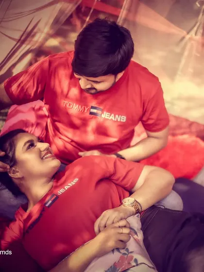An intimate and relaxed pre-wedding photo, capturing a tender moment between the couple in a cozy, romantic tent setup.