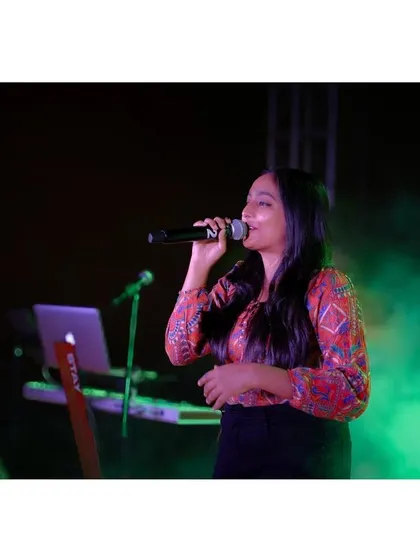 A candid moment from a live show, with the green stage smoke creating a magical atmosphere. I love how these photos capture the mood of our concerts.
