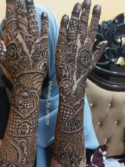 An angled view of the same intricate bridal henna.