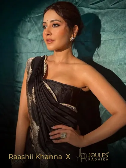 Raashii Khanna redefining bold elegance in a modern black saree, her look completed with my statement earcuffs and a striking cocktail ring.