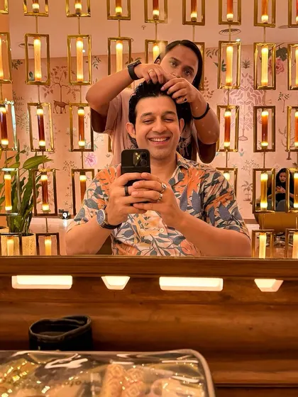 Getting a quick touch-up from the hair stylist between takes. Long shoot days mean you have to stay fresh and camera-ready at all times.