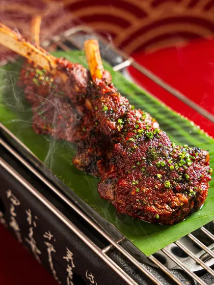 Lamb chops fresh off the grill, with visible steam rising. Capturing action and heat is key to making grilled dishes look irresistible.