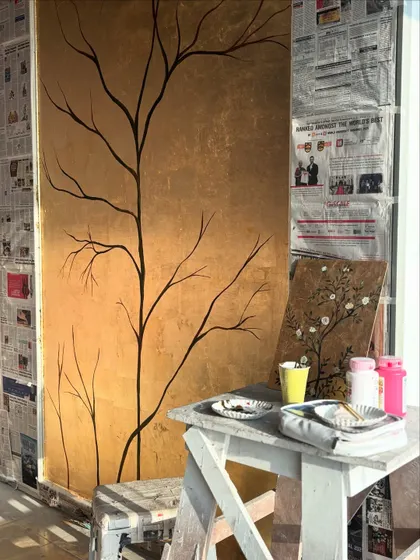 This was my workspace during the gold leaf mural project. You can see my small-scale practice board on the easel, where I test out colors and techniques before applying them to the main wall.