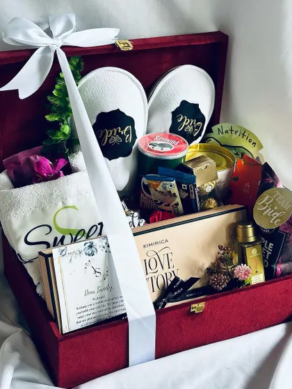 The ultimate bridal hamper, beautifully tied with a white satin ribbon. This gift is ready to be presented to the special bride-to-be.
