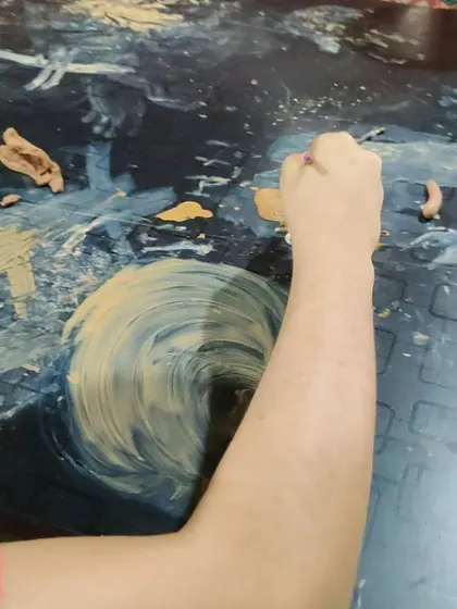 We painted with clay today! Using wet clay, or slip, as paint is a fantastic sensory activity for kids. The swirling motions and messy fun are a great way for children to express themselves freely.