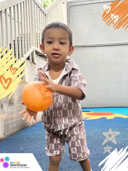 A toddler practices his throwing and catching skills. Our play areas are equipped with a variety of age-appropriate toys to encourage active, physical development.