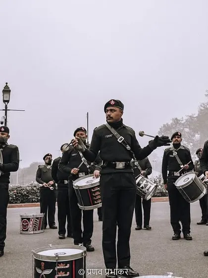 A wide shot of the military band practicing for the parade. This image captures the coordinated effort and the scale of the musical contingent against the backdrop of a foggy Delhi morning.