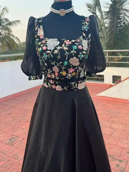 The square neckline and puff sleeves give this modern lehenga a trendy look.
