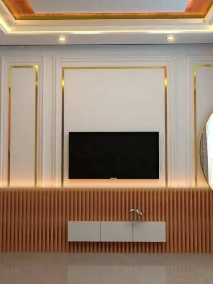 This 3D concept for a TV wall combines classic and modern elements. We used traditional wall molding with gold-finished inlays and paired it with contemporary fluted wood paneling below for a unique, layered look.