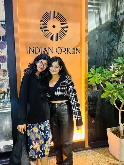 Posing with my talented guitarist outside our gig at Indian Origin. We work together seamlessly to provide a polished and professional musical experience.