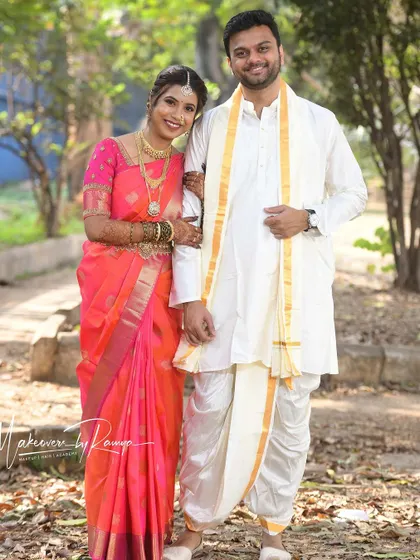 The full traditional attire for this beautiful South Indian couple. Santhoshi's look features classic gold temple jewelry and a perfectly draped saree.