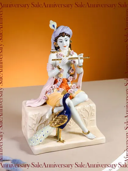A divine idol of Lord Krishna, captured here for my anniversary sale. The delicate colors and serene posture, complete with his flute and a peacock, make this a beautiful piece to grace your home with spiritual luxury.