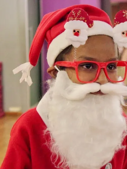 One of our students gets fully into the holiday spirit, dressed as Santa Claus. We love seeing their creativity and festive fun.