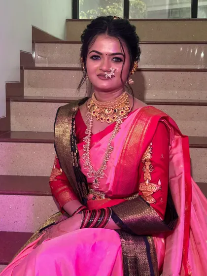 A close-up of the bride, showing the flawless makeup and the intricate details of her `Paithani` saree and jewelry.