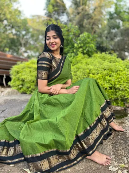 A traditional green cotton kurti with a zari border, styled as a long dress. This look is both comfortable and elegant, perfect for a temple visit or a casual festive gathering.
