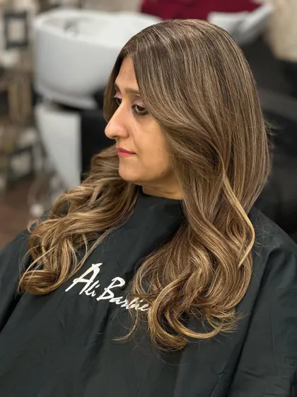 The side profile shows the beautiful layers and warm blonde tones.