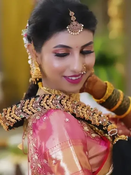 This shot showcases the beautiful bridal braid accessory and how it integrates with the hairstyle and the overall traditional look.