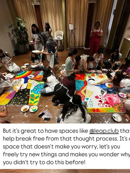 A wide shot of the leap.club members working on the floor, completely immersed in the collaborative painting process. It was a space of freedom and creativity.