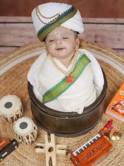 A slightly different angle of our newborn Warkari, showcasing the traditional cap and attire against a rustic, earthy backdrop.